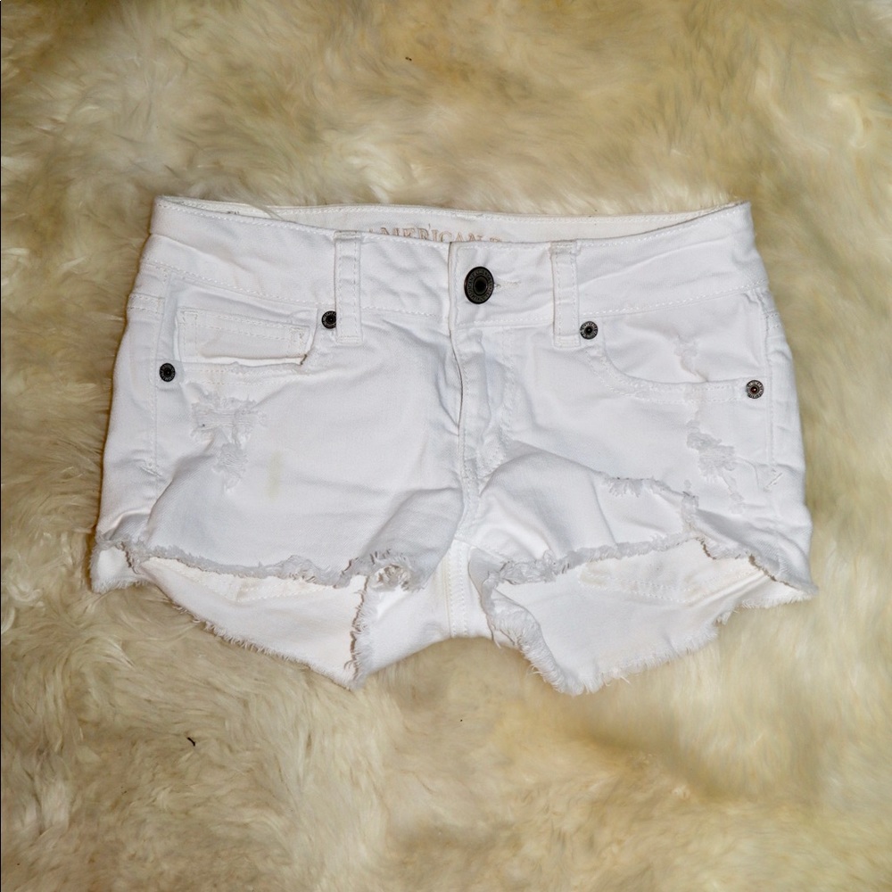 White ripped shorts